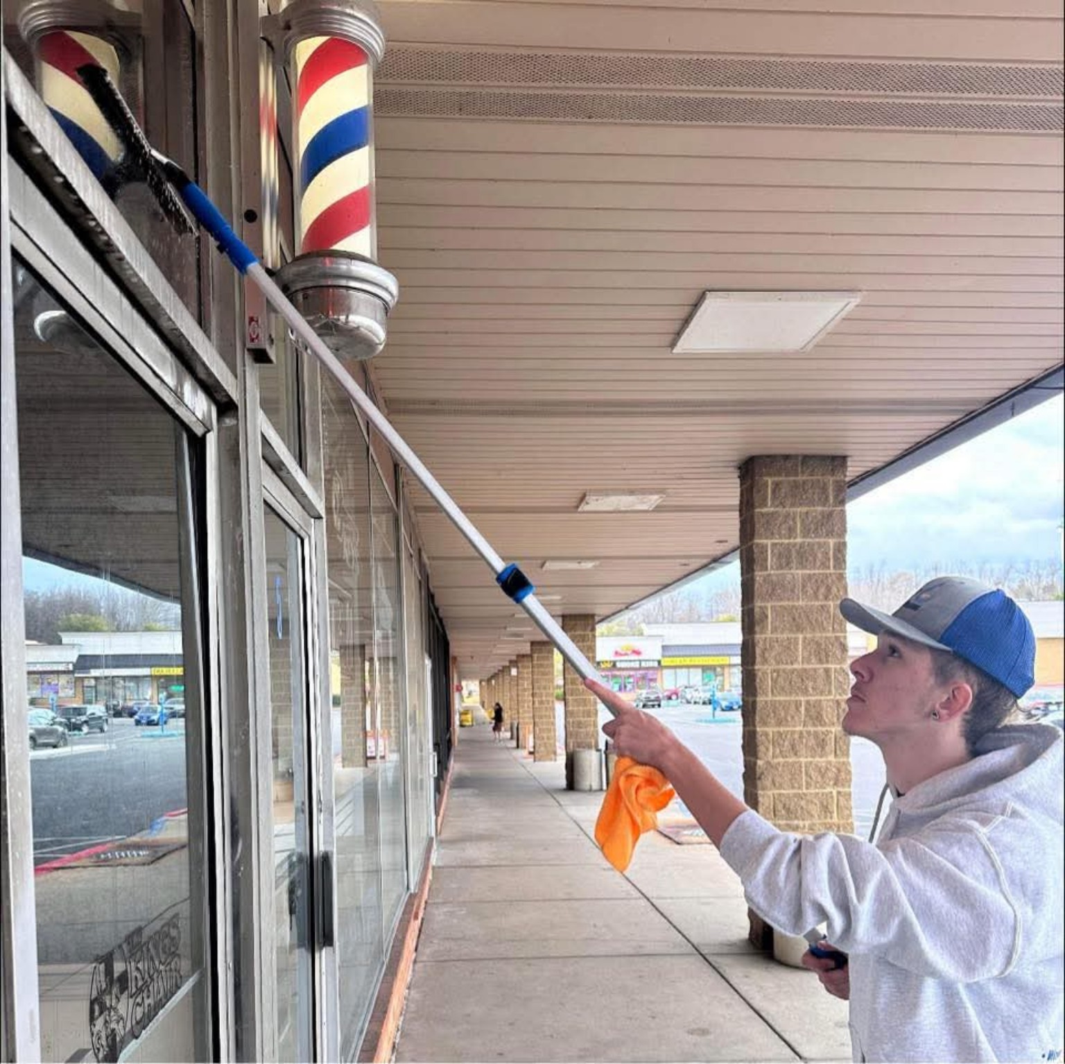 Storefront window cleaning with an extension pole